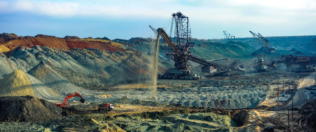 Heavy equipment moving overburden at a terrestrial mine